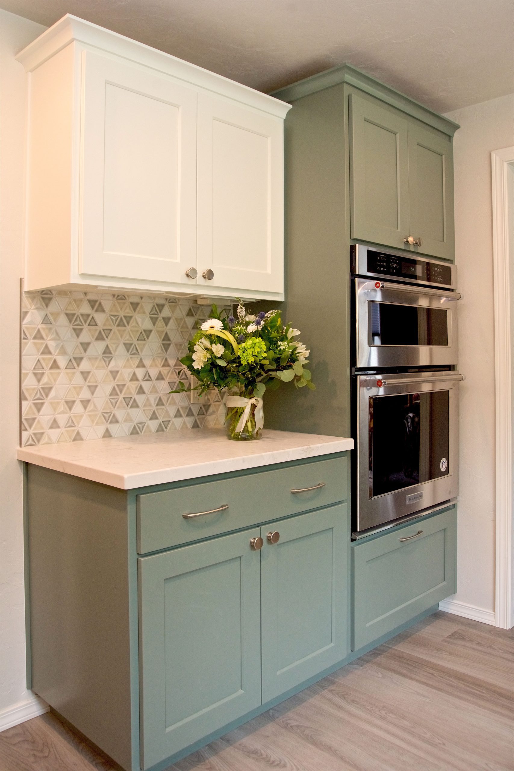 Retreat Green Parchment White Cabinetry with Stainless Steel Appliance